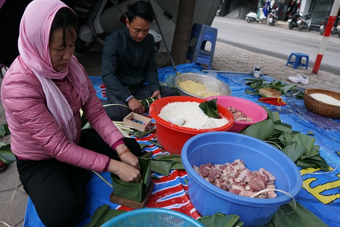 nguoi ha noi ru nhau goi luoc banh chung don tet ngay tren pho