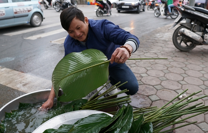 nguoi ha noi ru nhau goi luoc banh chung don tet ngay tren pho