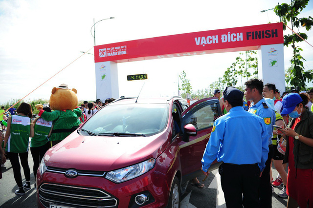 o to lao ve vach dich duong chay marathon khi van dong vien dang nuoc rut