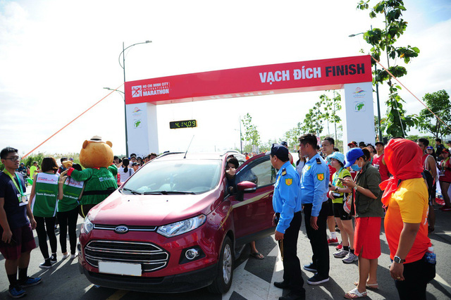 o to lao ve vach dich duong chay marathon khi van dong vien dang nuoc rut